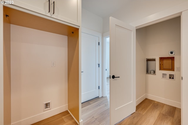 washroom featuring cabinets, light wood-type flooring, electric dryer hookup, and hookup for a washing machine