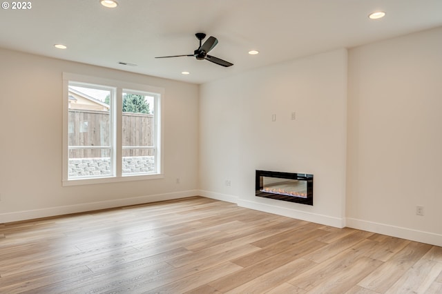 unfurnished living room with light hardwood / wood-style floors and ceiling fan