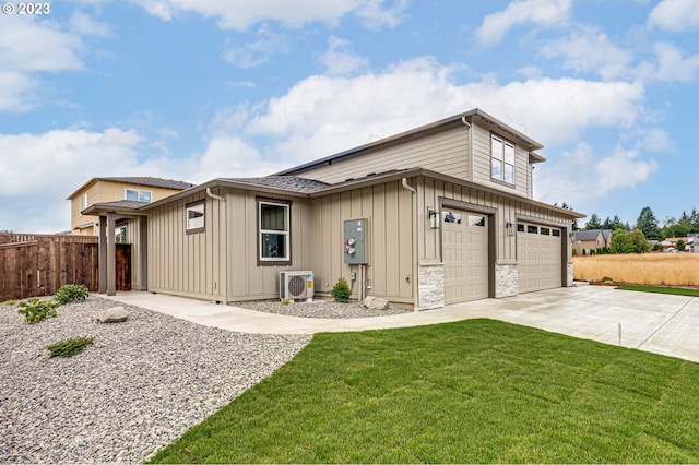 view of front of house featuring a garage, a front lawn, and ac unit