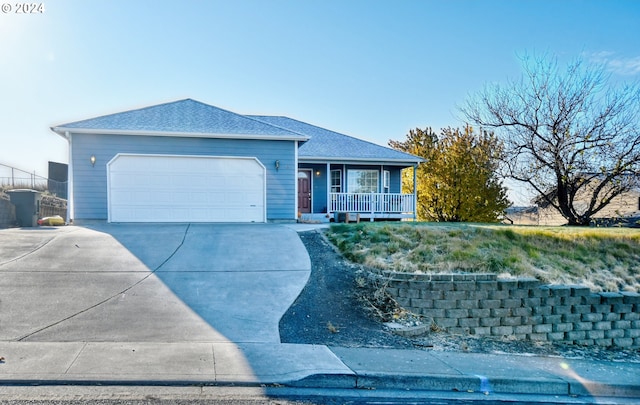 single story home featuring a garage and covered porch