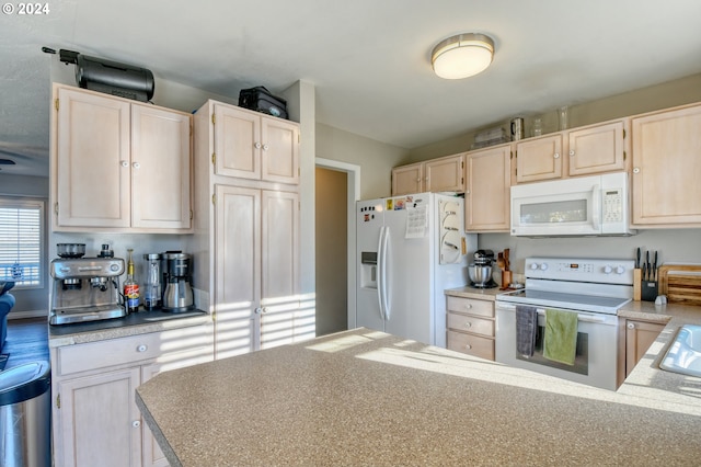 kitchen with light brown cabinets and white appliances