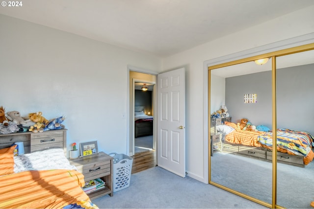 bedroom featuring a closet and light colored carpet