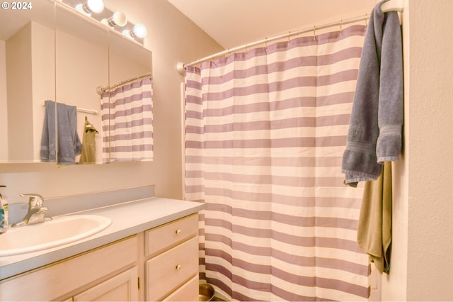 bathroom with walk in shower and vanity