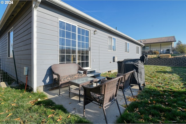 back of property featuring a yard, a patio, and an outdoor living space