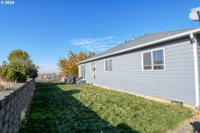 view of home's exterior with a lawn