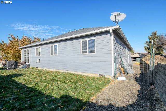 view of property exterior with a lawn