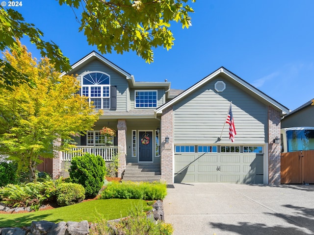 view of front facade with a garage and a porch