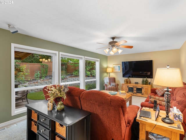 carpeted living room with ceiling fan