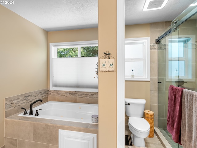 bathroom featuring tile patterned floors, independent shower and bath, toilet, and a textured ceiling