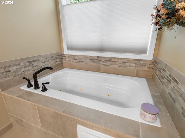 bathroom featuring tiled tub