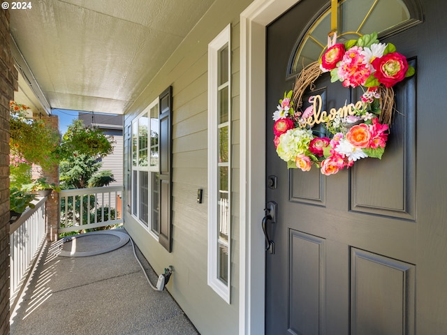 view of exterior entry featuring a porch