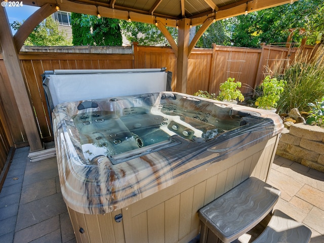 view of patio / terrace with a hot tub