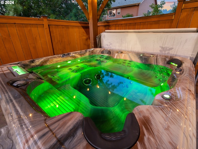 details with wood walls and a hot tub