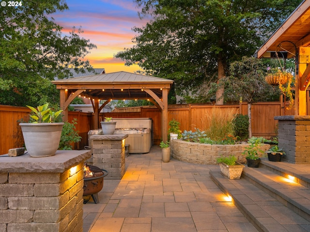 patio terrace at dusk featuring a gazebo