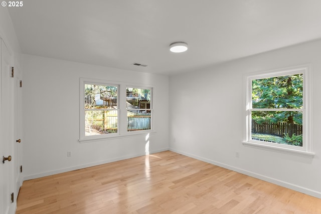 unfurnished room with light hardwood / wood-style floors and a wealth of natural light