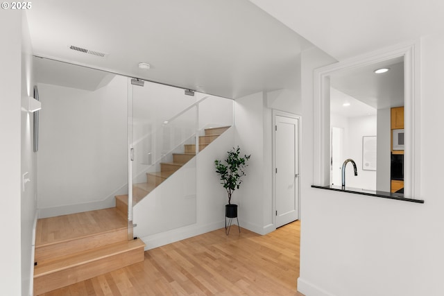 staircase featuring wood-type flooring