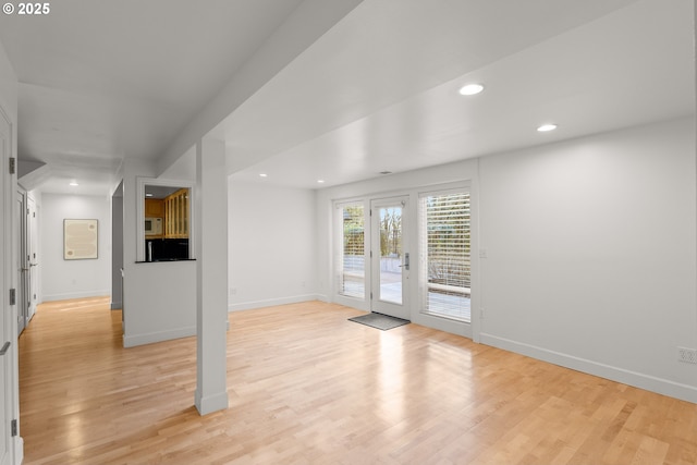 unfurnished room with french doors and light hardwood / wood-style flooring