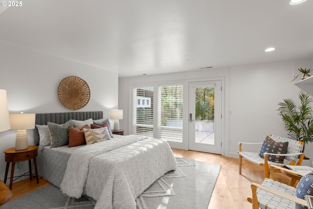 bedroom with light hardwood / wood-style floors and access to outside