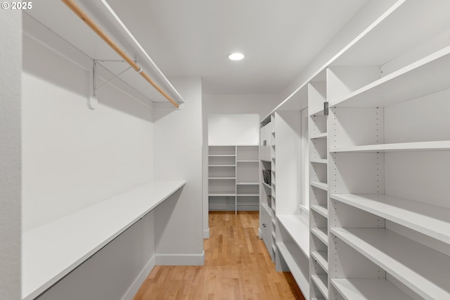 walk in closet featuring light hardwood / wood-style flooring