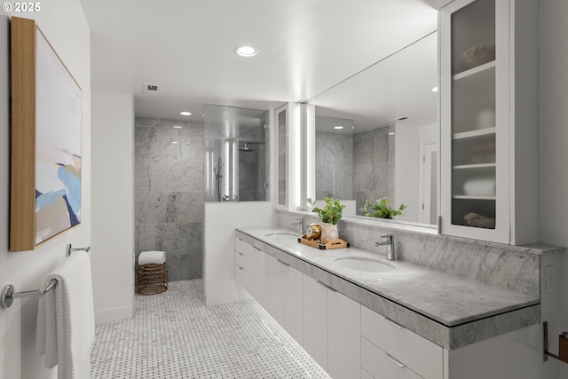 bathroom with tile walls, walk in shower, and vanity