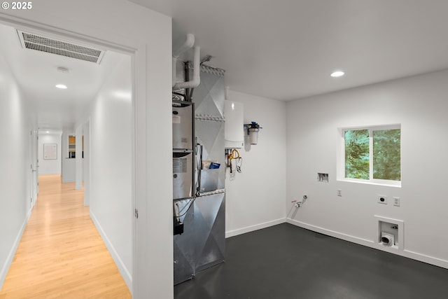 laundry room featuring hardwood / wood-style floors, hookup for an electric dryer, and washer hookup