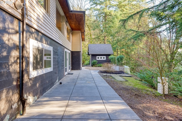 view of side of property with a patio