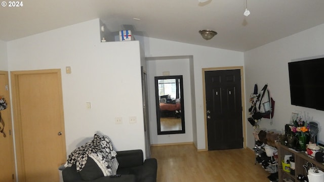 living room featuring light hardwood / wood-style flooring and lofted ceiling