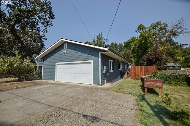 view of property exterior with a garage and fence