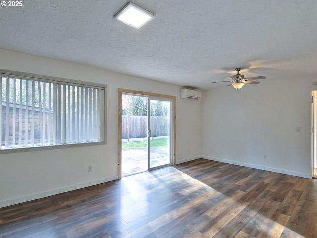 unfurnished room featuring a textured ceiling, a wall unit AC, ceiling fan, and dark hardwood / wood-style flooring