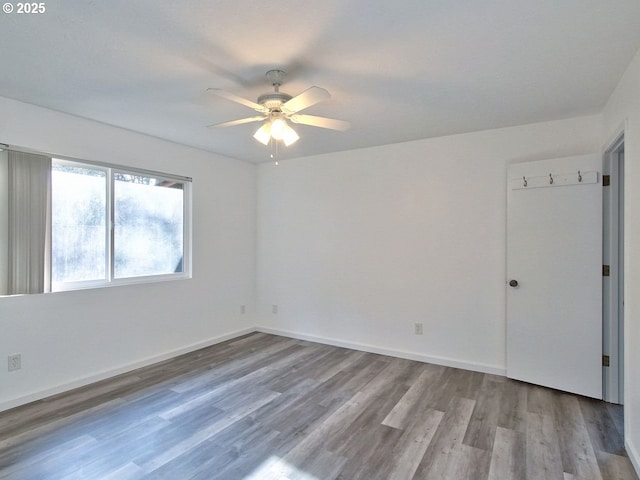 spare room with light wood-type flooring and ceiling fan