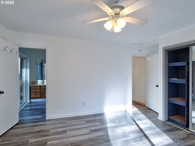 spare room featuring dark wood-type flooring and ceiling fan