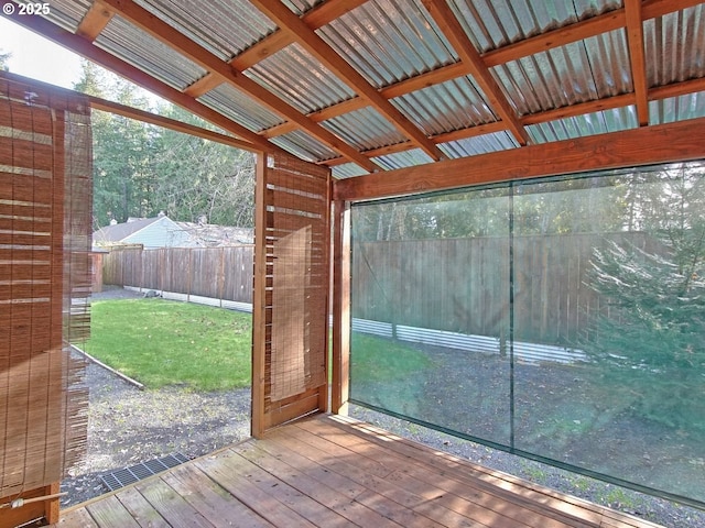 unfurnished sunroom featuring lofted ceiling