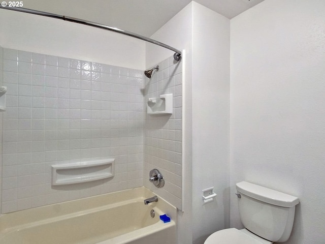 bathroom featuring toilet and  shower combination