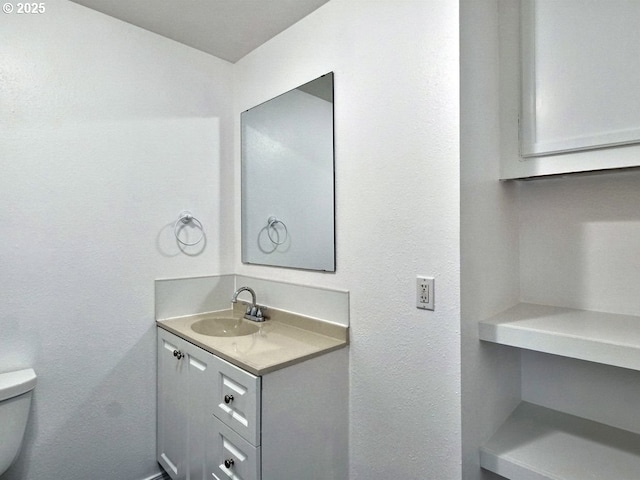 bathroom featuring toilet and vanity