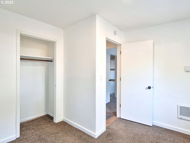 unfurnished bedroom featuring a closet and carpet flooring