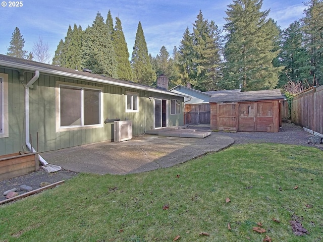 back of house with a patio area and a yard