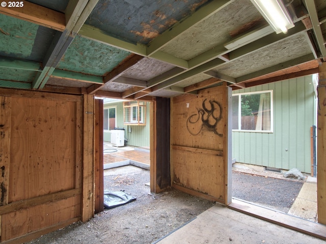 miscellaneous room with ac unit and wood walls