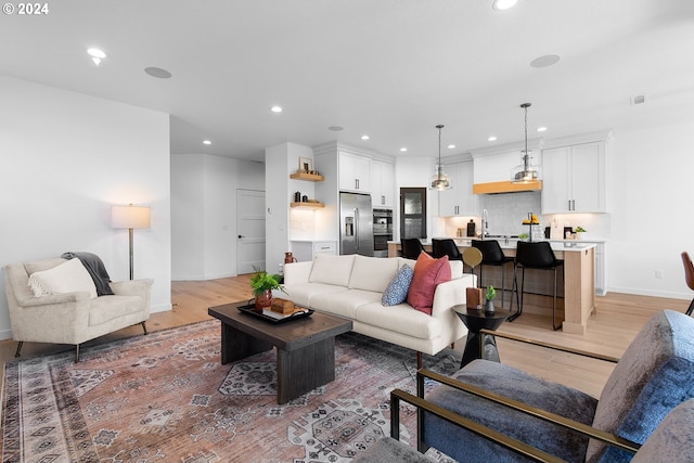 living room with sink and light hardwood / wood-style flooring