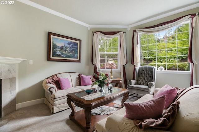 carpeted living room featuring a fireplace, crown molding, and a wealth of natural light