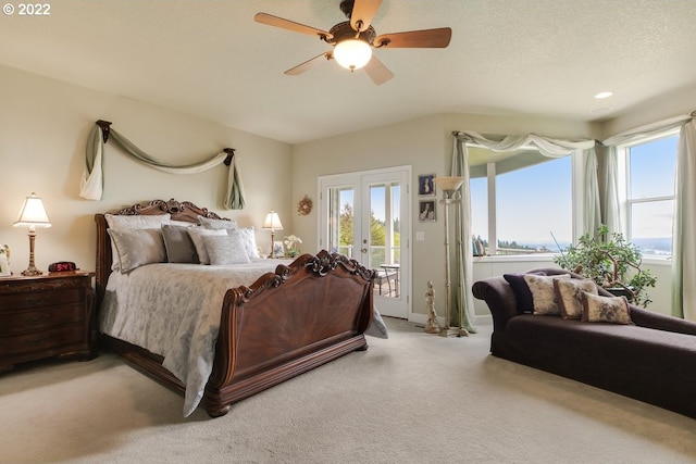 carpeted bedroom featuring a textured ceiling, ceiling fan, access to outside, and french doors