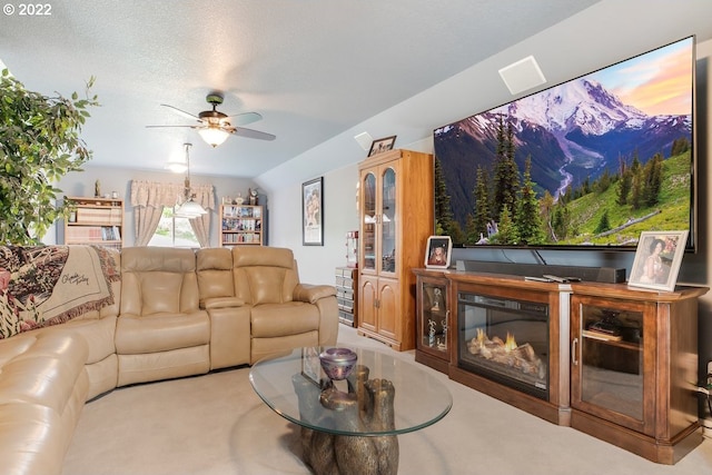 living room featuring light carpet, a textured ceiling, and ceiling fan