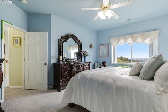 bedroom with light carpet and ceiling fan