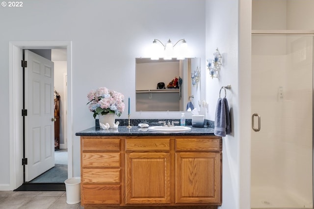 bathroom featuring tile flooring, vanity, and an enclosed shower