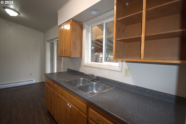 kitchen with sink, a baseboard radiator, dark hardwood / wood-style floors, and vaulted ceiling