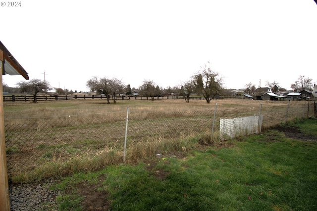 view of yard with a rural view