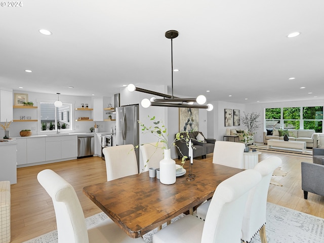 dining space featuring sink and light hardwood / wood-style floors