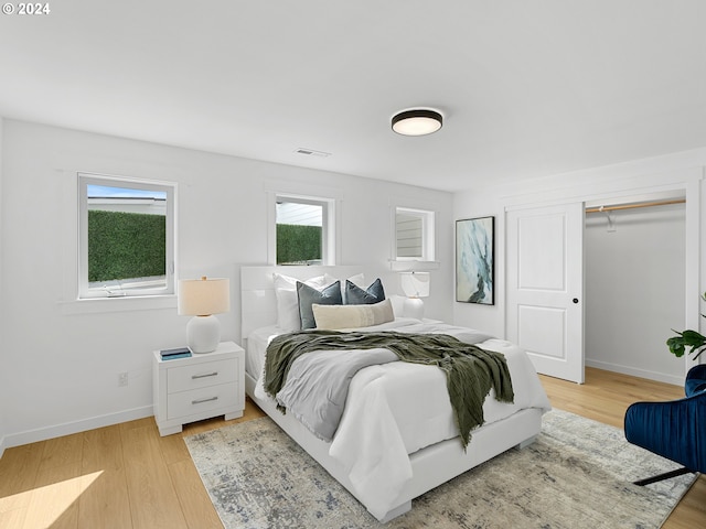 bedroom featuring a closet and light wood-type flooring