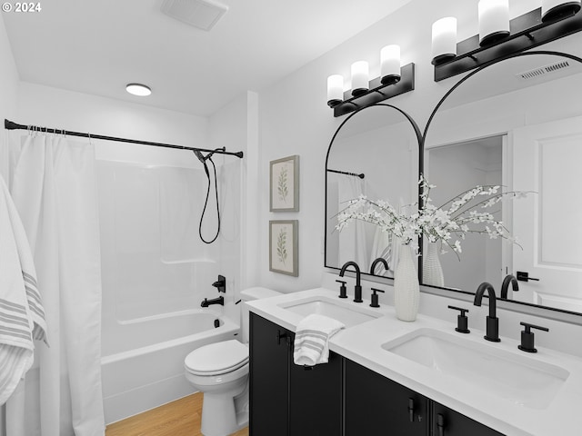 full bathroom featuring vanity, wood-type flooring, toilet, and shower / bath combo with shower curtain