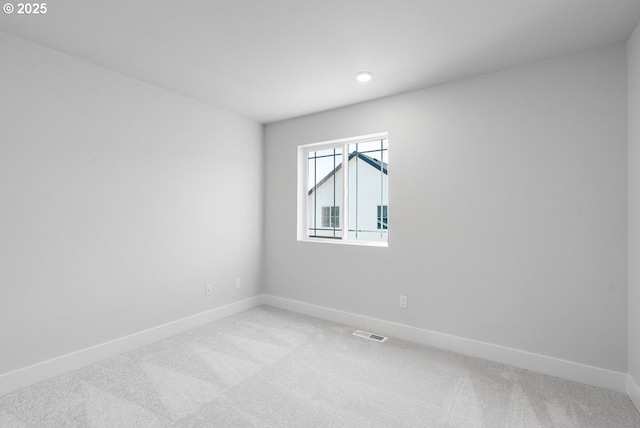spare room with recessed lighting, visible vents, baseboards, and light carpet