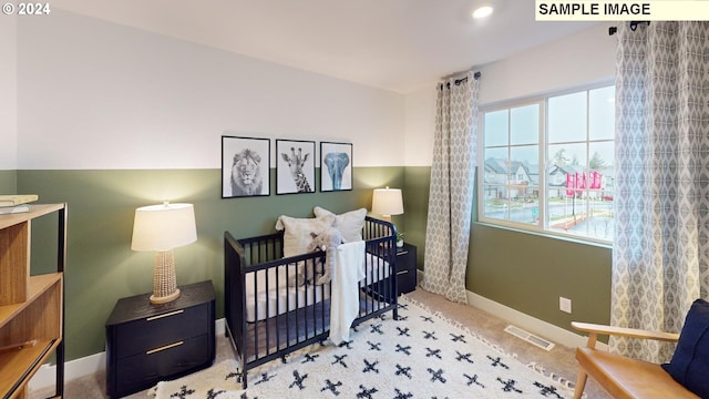 carpeted bedroom with a crib